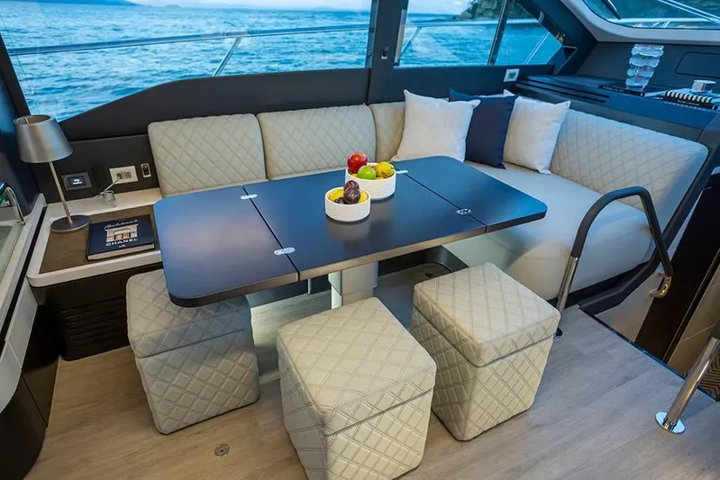  Yacht Photos Pics Manufacturer Provided Image: Luxurious interior of 2025 Schaefer 600 yacht with elegant seating and dining area.