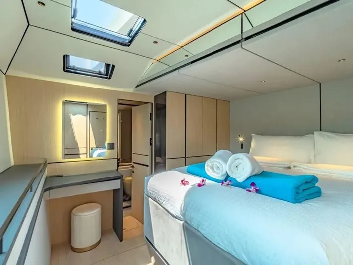 Jack Yacht Photos Pics Luxurious 2023 McConaghy MC75 yacht cabin with skylights, modern decor, and plush bedding.