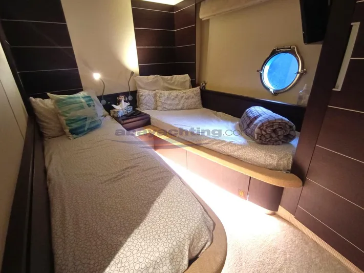  Yacht Photos Pics Luxurious cabin interior of 2004 Azimut 68S yacht with twin beds and porthole.