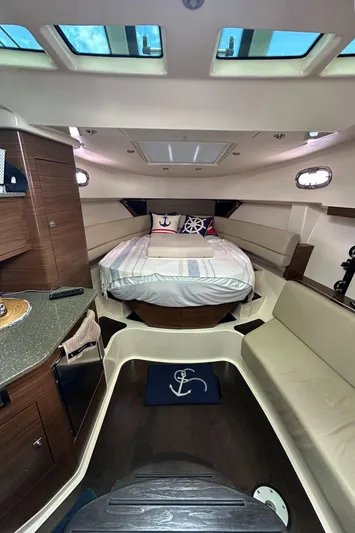  Yacht Photos Pics 2015 Boston Whaler 345 Conquest cabin interior with bed, seating, and skylights.