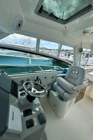  Yacht Photos Pics 2015 Boston Whaler 345 Conquest helm with steering wheel and captain's chair.