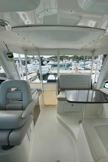  Yacht Photos Pics Interior of a 2015 Boston Whaler 345 Conquest boat with seating and table.