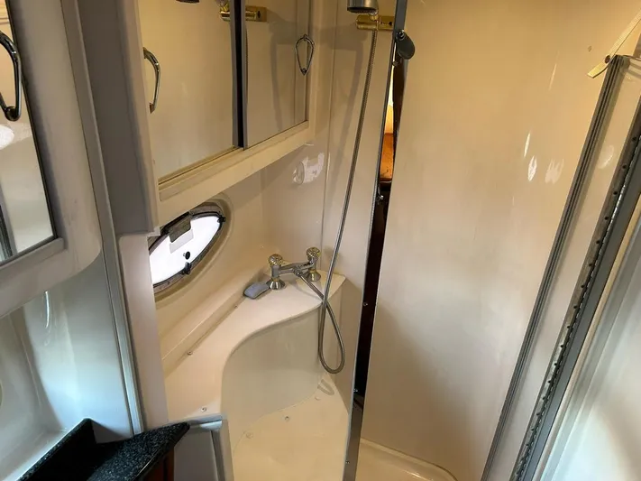 River Dancer Yacht Photos Pics Bathroom interior of 2004 Carver 466 Motor Yacht with shower and porthole window.