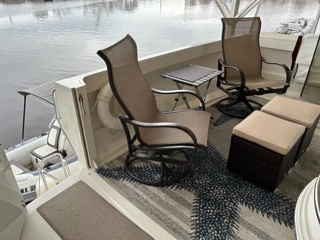 River Dancer Yacht Photos Pics 2004 Carver 466 Motor Yacht deck with chairs, table, and water view.