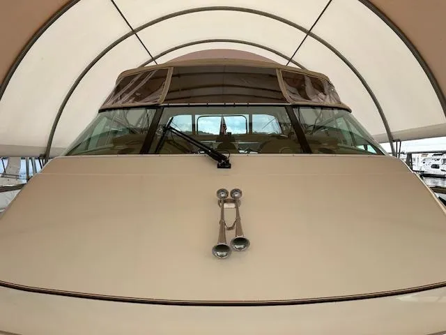 River Dancer Yacht Photos Pics 2004 Carver 466 Motor Yacht under canopy, front view with windows and horns visible.