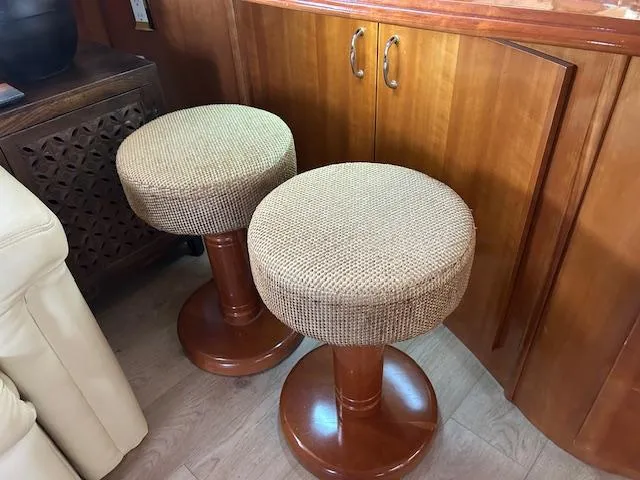 River Dancer Yacht Photos Pics Two cushioned stools in a 2004 Carver 466 Motor Yacht interior.