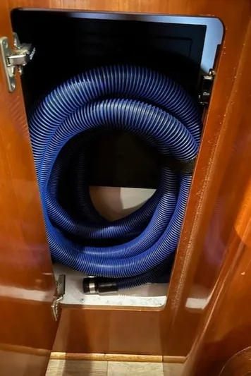 River Dancer Yacht Photos Pics Coiled blue hose in a wooden cabinet on a 2004 Carver 466 Motor Yacht.