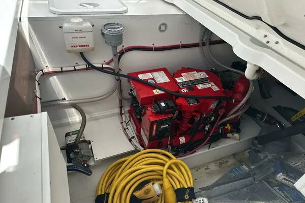 Keys Please! Yacht Photos Pics 2024 Jeanneau Leader 9.0 WA engine compartment with battery, wiring, and yellow cable.