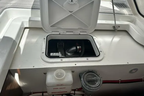 Keys Please! Yacht Photos Pics 2024 Jeanneau Leader 9.0 WA boat storage compartment with open hatch and visible equipment.