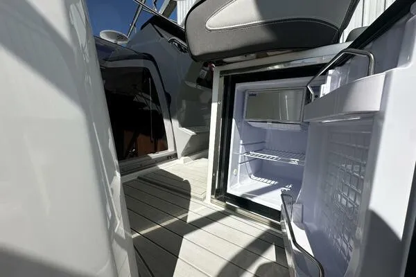 Keys Please! Yacht Photos Pics 2024 Jeanneau Leader 9.0 WA boat interior with open mini fridge on deck.