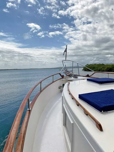 Yacht Photos Pics 1981 Grand Banks 42 Europa yacht on calm water under a partly cloudy sky.