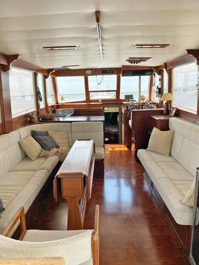  Yacht Photos Pics Interior of 1981 Grand Banks 42 Europa yacht, featuring spacious seating and wooden finishes.