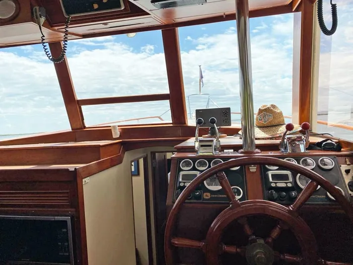  Yacht Photos Pics Interior helm of 1981 Grand Banks 42 Europa yacht with wooden steering wheel.