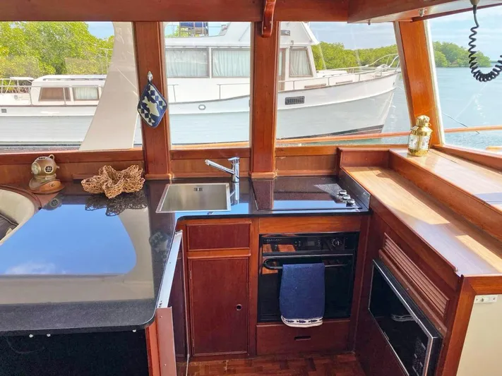  Yacht Photos Pics Interior of 1981 Grand Banks 42 Europa yacht with modern kitchen and scenic window view.