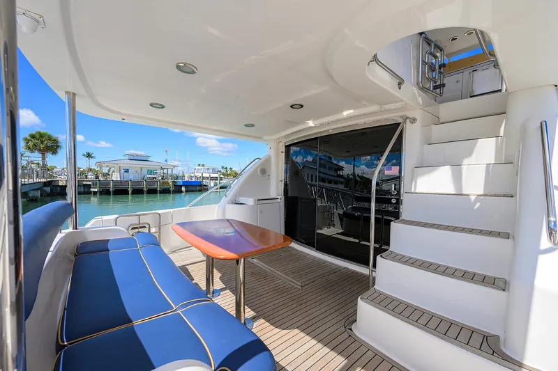 Aye Roller Yacht Photos Pics Luxurious 2008 Neptunus 62 Flybridge yacht with elegant seating and scenic marina view.