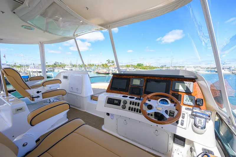 Aye Roller Yacht Photos Pics Luxurious 2008 Neptunus 62 Flybridge yacht interior with modern navigation equipment and scenic marina view.
