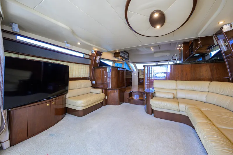 Aye Roller Yacht Photos Pics Luxurious interior of 2008 Neptunus 62 Flybridge yacht with plush seating and modern entertainment system.