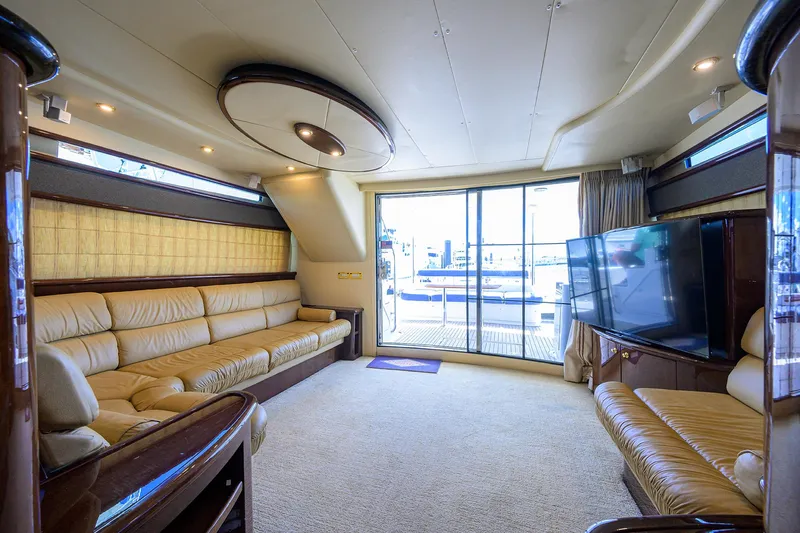 Aye Roller Yacht Photos Pics Luxurious interior of 2008 Neptunus 62 Flybridge yacht with plush seating and large TV.