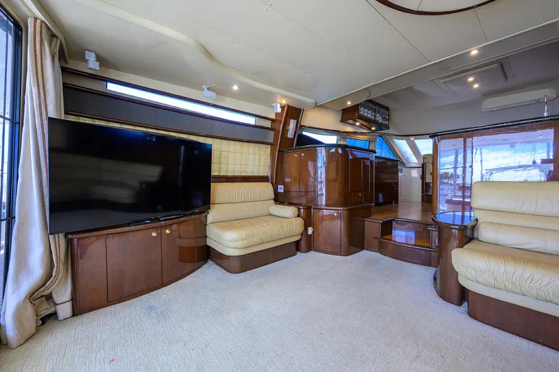 Aye Roller Yacht Photos Pics Luxurious interior of a 2008 Neptunus 62 Flybridge yacht with plush seating and large TV.