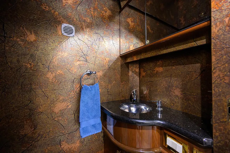 Aye Roller Yacht Photos Pics Luxurious bathroom in 2008 Neptunus 62 Flybridge yacht with elegant design and blue towel.