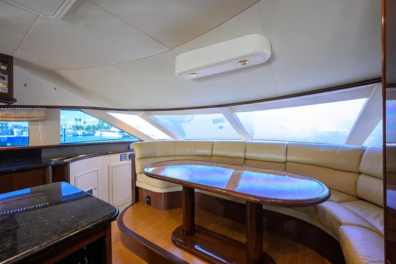 Aye Roller Yacht Photos Pics Luxurious interior of 2008 Neptunus 62 Flybridge yacht with elegant seating and dining area.