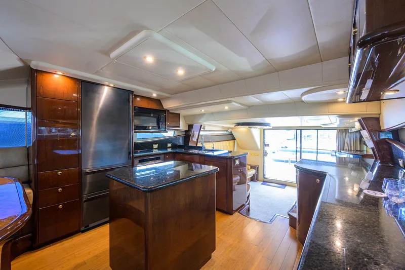 Aye Roller Yacht Photos Pics Luxurious interior of 2008 Neptunus 62 Flybridge yacht with modern kitchen and elegant design.