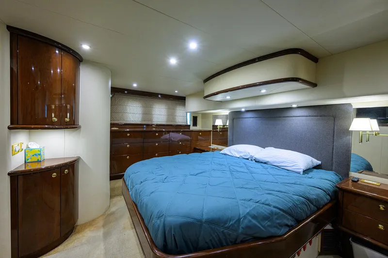 Aye Roller Yacht Photos Pics Luxurious bedroom in 2008 Neptunus 62 Flybridge yacht with elegant wood furnishings.