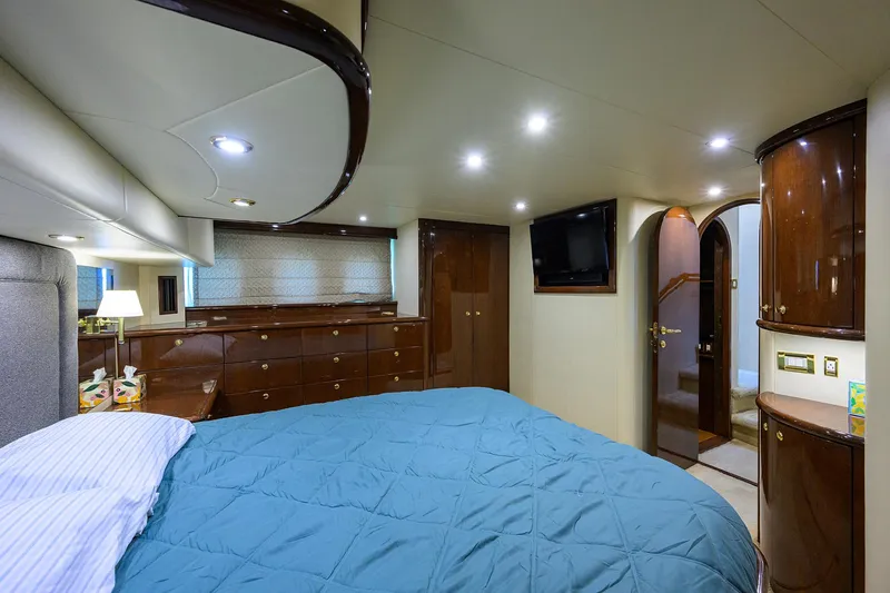 Aye Roller Yacht Photos Pics Luxurious bedroom interior of 2008 Neptunus 62 Flybridge yacht with elegant wood finishes.