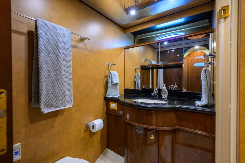Aye Roller Yacht Photos Pics Luxurious bathroom in 2008 Neptunus 62 Flybridge yacht with elegant wood and granite finishes.
