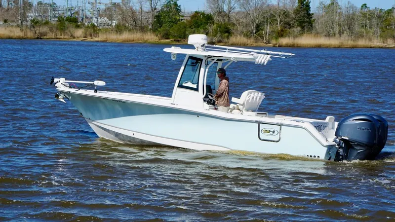 Yacht Photos Pics 2023 Sea Hunt Gamefish 27 Forward Seating boat cruising on a calm river.