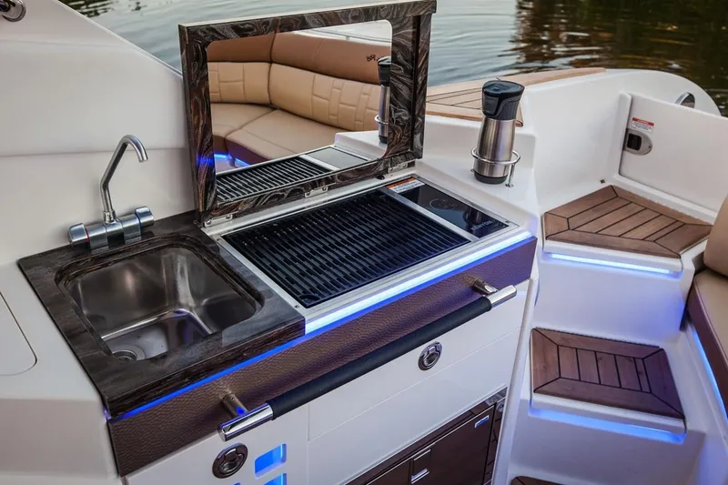  Yacht Photos Pics Manufacturer Provided Image: 2019 Sea Ray SLX 350 boat interior with sink, grill, and seating area.