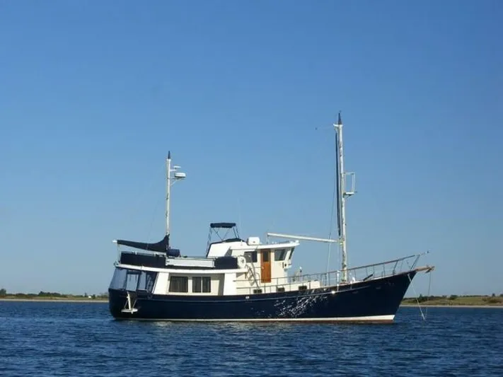Ursa Minor Yacht Photos Pics 1988 Kadey-Krogen Krogen 54 yacht on calm water under clear blue sky.