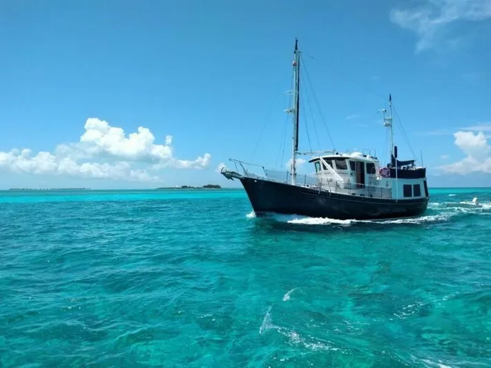 Ursa Minor Yacht Photos Pics Kadey-Krogen 54 yacht cruising in clear turquoise waters under a bright blue sky.