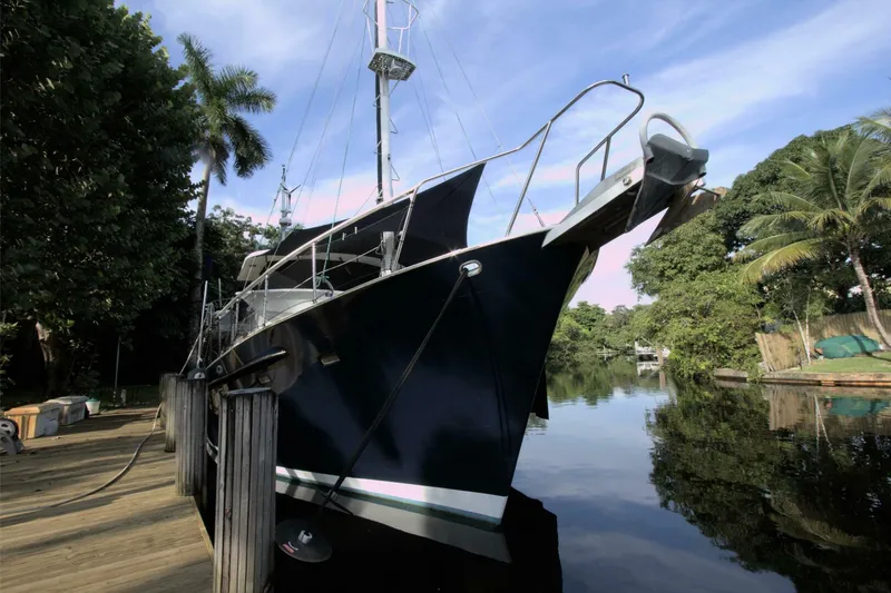 Ursa Minor Yacht Photos Pics 1988 Kadey-Krogen Krogen 54 yacht docked by lush tropical trees.
