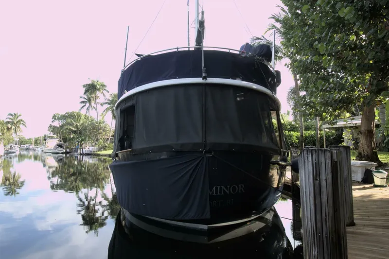 Ursa Minor Yacht Photos Pics 1988 Kadey-Krogen Krogen 54 yacht docked by a serene, tree-lined canal.
