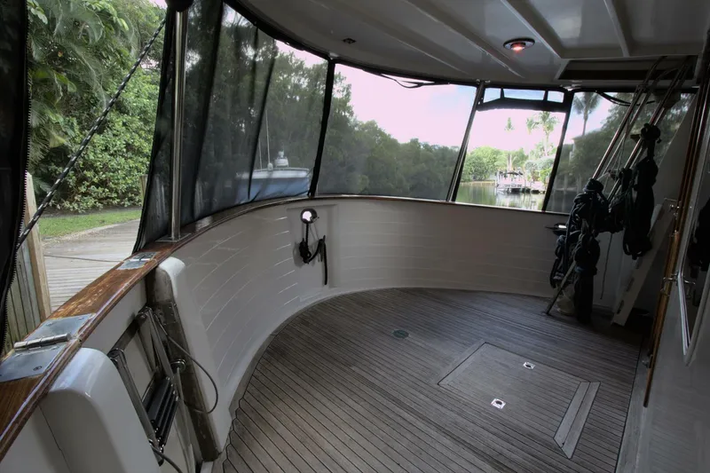 Ursa Minor Yacht Photos Pics Enclosed deck area of 1988 Kadey-Krogen Krogen 54 yacht with wooden flooring.