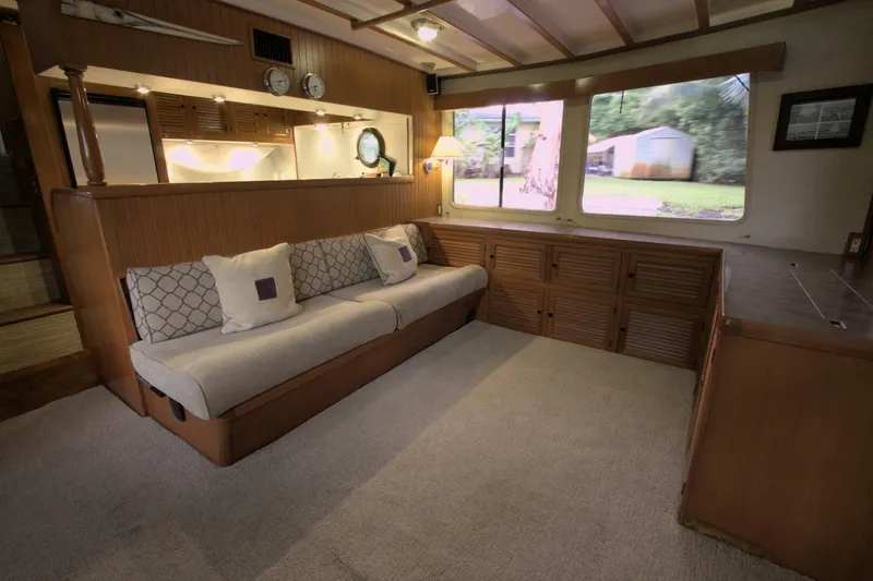 Ursa Minor Yacht Photos Pics Interior of 1988 Kadey-Krogen Krogen 54 yacht with cozy seating and large windows.