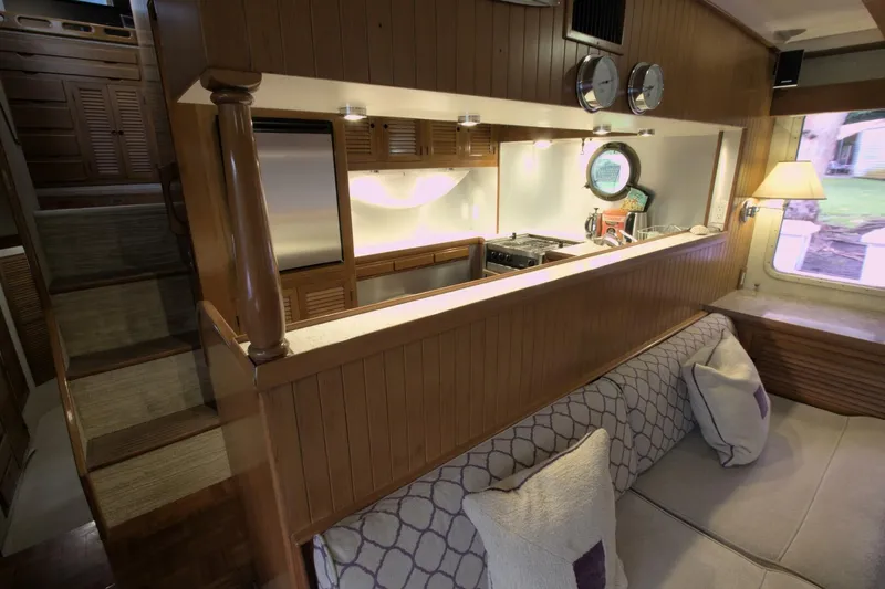 Ursa Minor Yacht Photos Pics Interior of 1988 Kadey-Krogen Krogen 54 yacht, featuring cozy seating and a compact kitchen.