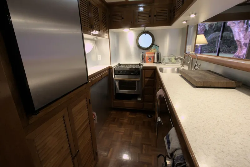 Ursa Minor Yacht Photos Pics 1988 Kadey-Krogen Krogen 54 yacht kitchen with modern appliances and wooden cabinetry.