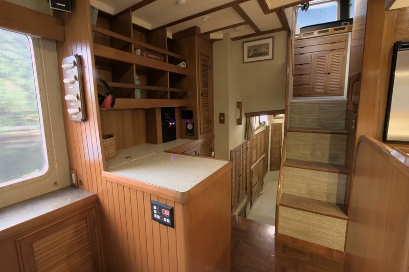 Ursa Minor Yacht Photos Pics Interior of 1988 Kadey-Krogen Krogen 54 yacht with wooden cabinetry and stairs.