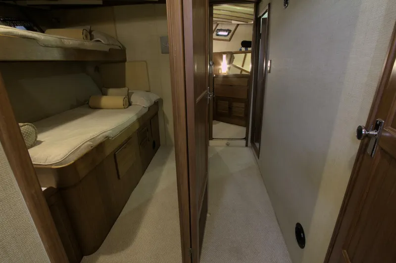 Ursa Minor Yacht Photos Pics 1988 Kadey-Krogen Krogen 54 interior with cozy bunk beds and wooden finishes.