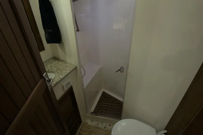 Ursa Minor Yacht Photos Pics Bathroom interior of 1988 Kadey-Krogen Krogen 54 yacht with shower and granite countertop.