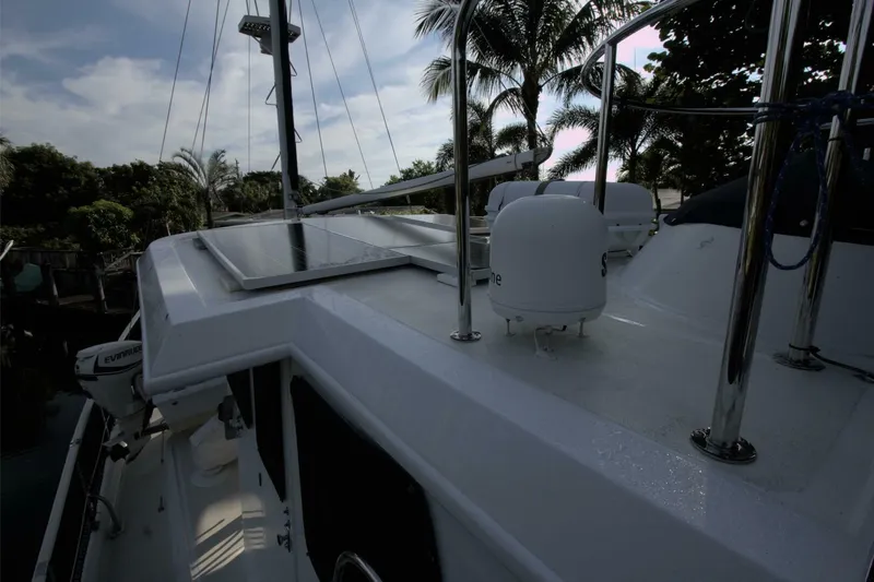 Ursa Minor Yacht Photos Pics 1988 Kadey-Krogen Krogen 54 yacht deck with solar panels and palm trees in background.