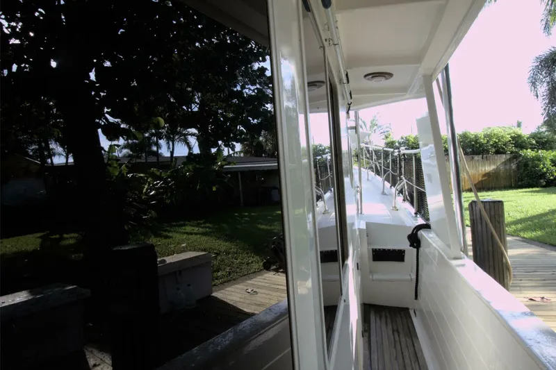 Ursa Minor Yacht Photos Pics 1988 Kadey-Krogen Krogen 54 yacht docked, showcasing side deck and lush surroundings.