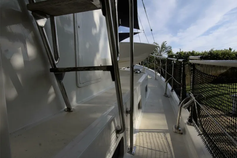 Ursa Minor Yacht Photos Pics 1988 Kadey-Krogen Krogen 54 yacht deck with ladder and railing, under a clear sky.
