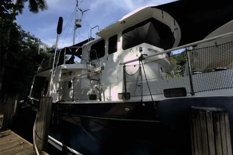 Ursa Minor Yacht Photos Pics 1988 Kadey-Krogen Krogen 54 yacht docked, featuring sleek design and shaded deck area.