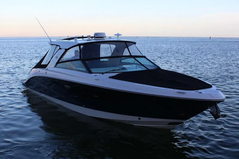 Sensei I Yacht Photos Pics Manufacturer Provided Image: 2021 Sea Ray SLX 400 boat on calm water at sunset.
