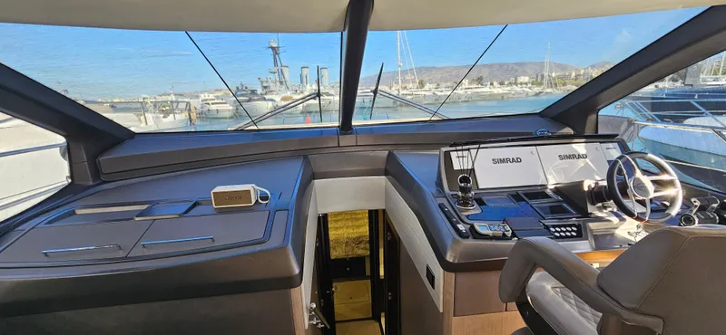  Yacht Photos Pics 2019 Sunseeker Manhattan 66 yacht helm with modern navigation equipment and panoramic view.