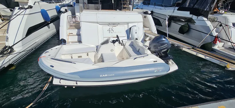  Yacht Photos Pics 2019 Sunseeker Manhattan 66 yacht docked with a small tender boat.