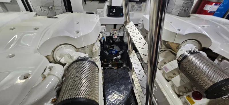  Yacht Photos Pics Engine room of a 2019 Sunseeker Manhattan 66 yacht, showcasing dual engines and machinery.